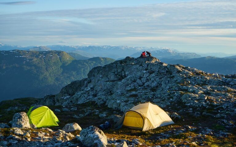a couple of tents sitting on top of a mountain